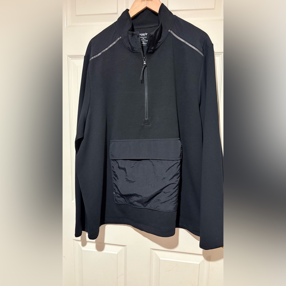 Jacket has a front pouch half zip